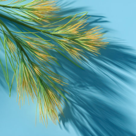A close-up captures delicate, golden-green plant stems against a vibrant blue backdrop, creating a contrasting visual. The textured shadows suggest daylight or artificial lighting. This image could be suitable for various design projects, providing a clean aesthetic. It offers possibilities for both commercial and editorial applications.の素材