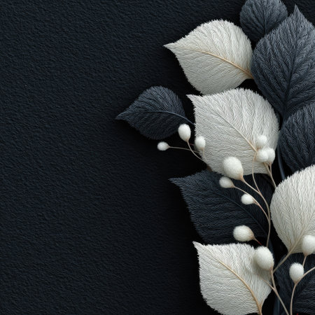 A close-up image features a stylized arrangement of black and white leaves against a dark backdrop. The composition highlights textures and contrasts, with detailed veining and soft lighting enhancing the visual appeal. Suitable for various design applications, the image can be used for decorative purposes.の素材