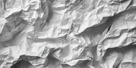 This image showcases a close-up of textured crumpled paper. The monochrome composition features various folds and wrinkles, creating a play of light and shadow. Suitable for backgrounds, textures, or design elements, it can enhance visual appeal across diverse applications. This abstract artwork might be utilized for a variety of commercial and editorial purposes.の素材