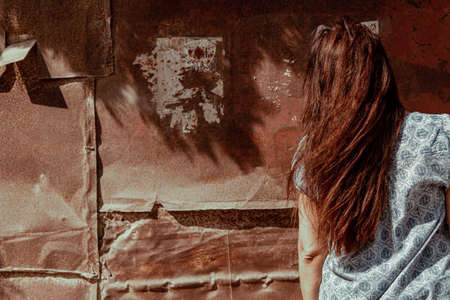 Girl in old abandoned ghost townの写真素材