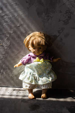 Ugly and scary dolls isolated in front of gray background.