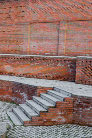 Red brick house and a city planted with green treesの写真素材