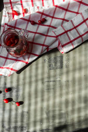 Red ripe dogrose infused in hot water and scattered on the tableの写真素材