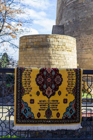 National carpets with Caucasian patterns are for sale in the old town on old stonesの写真素材