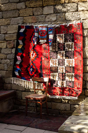 National carpets with Caucasian patterns are for sale in the old town on old stones