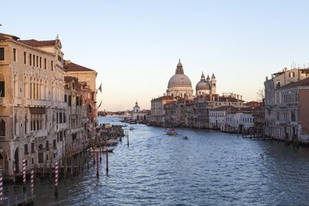 View from the Accademia Bridge of the Grand Canal and Basilica Santa Maria della Salute, Venice, Italy at sunsetの写真素材