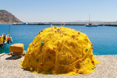 Fishing nets piled up on the quay of Aghia Galini, a small fishing port south of Creteの写真素材
