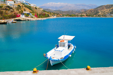 Small blue and white fishing boat moored at Aghia Galini's fishing port south of Crete.の写真素材