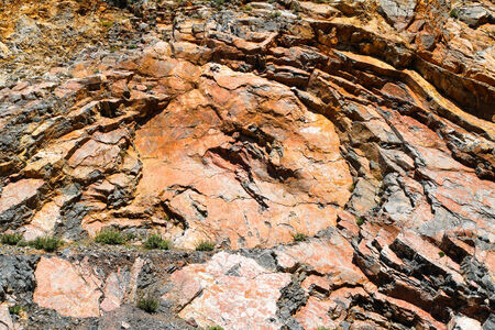 Corrosioned solid rock layers with a circular rugged and repetitive patern.の写真素材