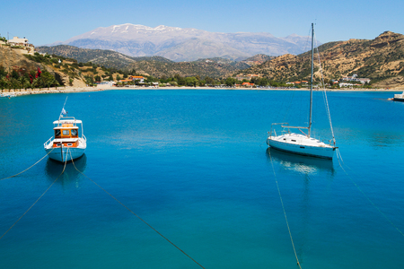 Small blue and white fishing and sailing boats moored at Aghia Galini's fishing port south of Crete.の写真素材