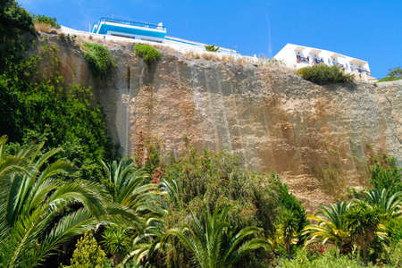 Housing build at the edge of a deep and steep cliff at village south of Crete.の写真素材