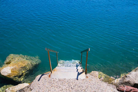 Stairway leading to the sea, serving as a embarcation and disembarcation point.