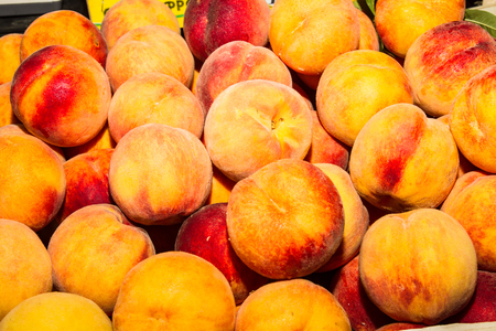 Delicious fresh juicy peaches  in local fruit marketの写真素材