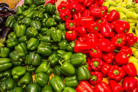 Fresh harvest of green and red peppers  in local fruit marketの写真素材