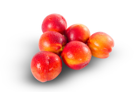 Fruit pile of ripe nectarines isolated on whiteの写真素材