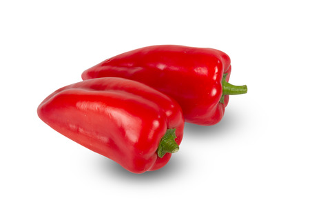 Two fresh red peppers isolated on whtiteの写真素材