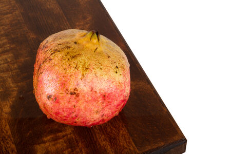 Fresh ripe, juicy, delicious pomegranate on oak woodの写真素材