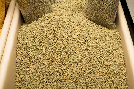 Dried brown lentils displayed for sale at local food market の写真素材