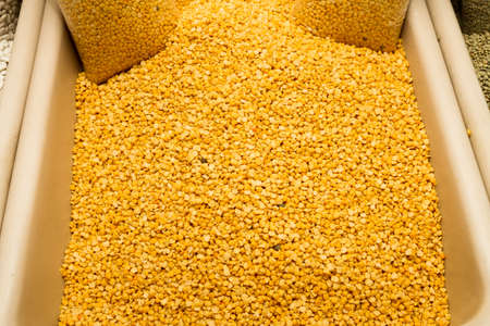 Dried yellow lentils displayed for sale at local food market の写真素材