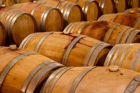Fermentation and aging of selected wine varieties in oak wine barrels in a winery cellar.の写真素材