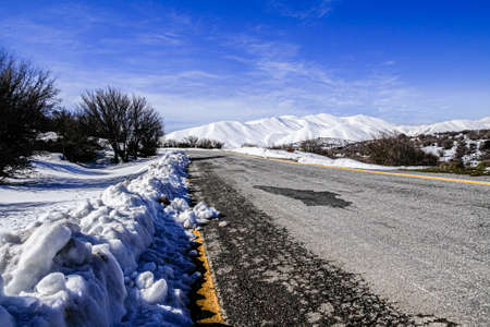 High mountains road winter wonderland tour, steep slopes, snow-capped rocky peaks for hiking trekking adventure recreation in Heraklion Crete, Greece.の写真素材