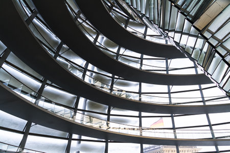 Thick layers of snow piled up on the rounded futuristic glass metal construction of Reichstag Dome in Berlin.の写真素材