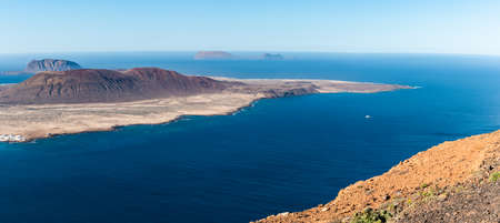 Aerial panoramic view of the volcanic island La Graciosa north cape coast, in Atlantic ocean, from Mirador del Rio, Lanzarote, Canary Islands, Spain. Travel concept.の写真素材