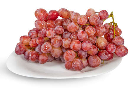 Plate of fresh red grapes isplated on whiteの写真素材