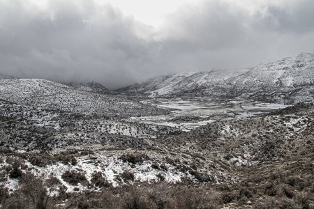 Freezing Nida Plateau Wilderness under massive thunderstorm clouds cumulus. Psiloritis mountain frozen heights, Heraklion, Crete Greeceの写真素材
