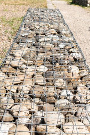 Galvanized gabion box filled with rocks. Nature park architecture landscapingの写真素材