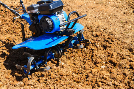 Small hand cultivator machine used to cultivate dry soil.の写真素材