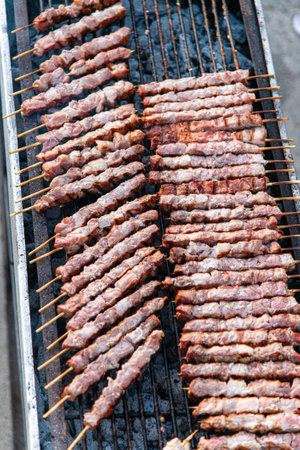 Roasting pork souvlaki meat sticks on hot charcoal fire grill. Pork, chicken Greek street food grilledの写真素材