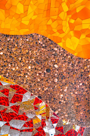 Abstract multicolored wall art glass crystals mosaic elements decoration. Detail of red, orange, yellow, gold, glass silver color waves of ornamental abstract mosaic art patterns texture background.の写真素材