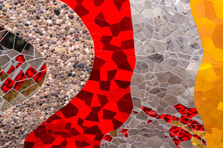 Abstract multicolored wall art glass crystals, pebles stones mosaic elements decoration. Detail of red, orange, yellow, gold, glass silver color waves of ornamental abstract mosaic art patterns texture background.の写真素材