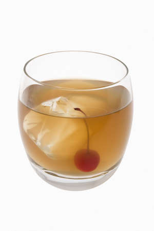 Whiskey Sour mixed drink with cherry garnish on white background