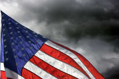 American Flag flys against Storm cloudsの写真素材