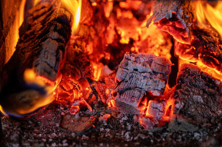 Close-up of a burning fire in a brick fireplace. Birch firewood.