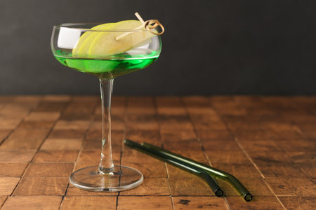 Classik Apple martini - appletini, cold summer cocktail with gin, apple liqueur, dry vermouth and ice on the black background. Copy space for text. High quality photoの写真素材