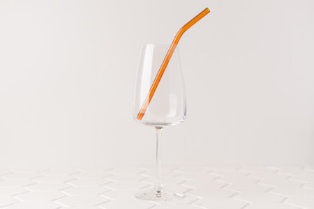Colorful reusable glass straws in the glass on white background. An alternative replacement for classic disposable plastic drinking straw, eco-friendly, zero waste. Cope space for text.の写真素材