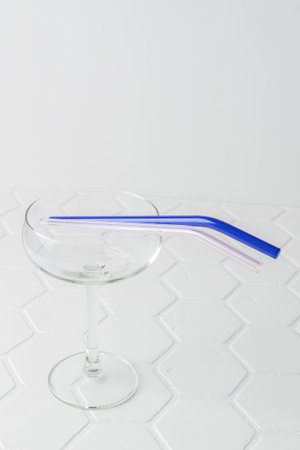 Colorful reusable glass straws in the glass on white background. An alternative replacement for classic disposable plastic drinking straw, eco-friendly, zero waste. Cope space for textの写真素材