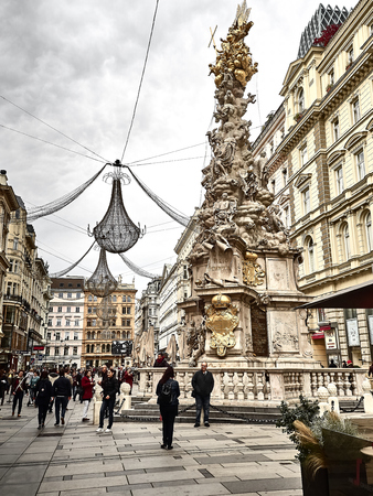 Vienna, Austria - November 1, 2018 - Shot of the Graben street and the Wiener PestsÃ¤ule statue, a monument to remember the Plague in 1679. Poeple are walking around to go shopping and visit the cityのeditorial素材