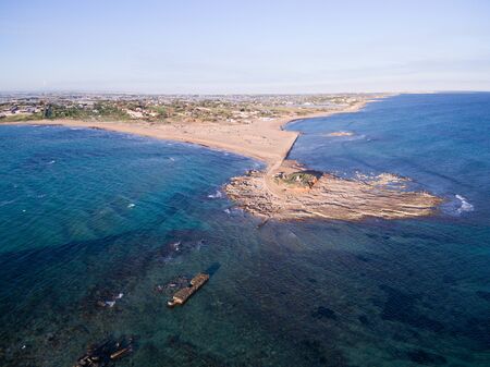 Aerial view at sunset of the beach of the Isola delle Correnti, near Portopalo, the southern corner in Sicily, Italyの写真素材