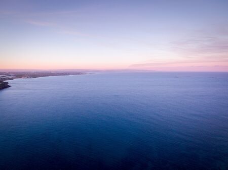 Wondeful aerial view at sunset of the coastline of Portopalo, a town in the south of Sicily. The...