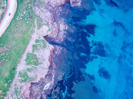 Wondeful aerial view at sunset of the coastline of Portopalo, a town in the south of Sicily. The shot is taken during a beautiful sunny dayの写真素材