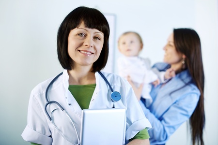 Smiling doctor holding tabletの写真素材
