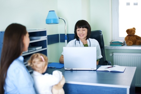 Mother and baby girl at doctors officeの写真素材