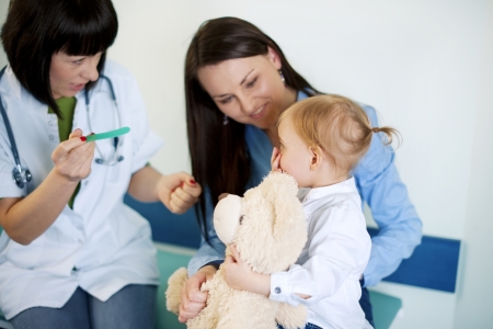 Doctor trying to exam babyの写真素材
