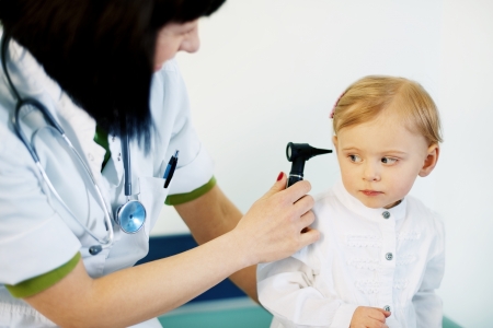 Pediatrician doing ear exam of baby girlの写真素材