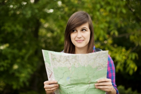 Beautiful young woman holding a mapの写真素材