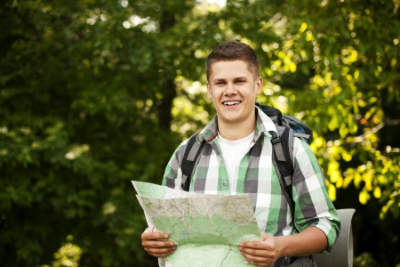 Man holding a map in forestの写真素材